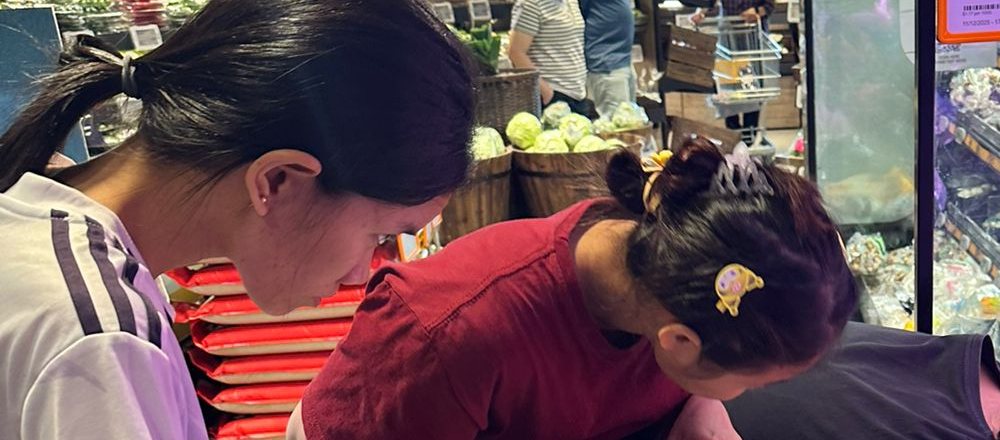 New Days helper choosing fresh groceries at the supermarket
